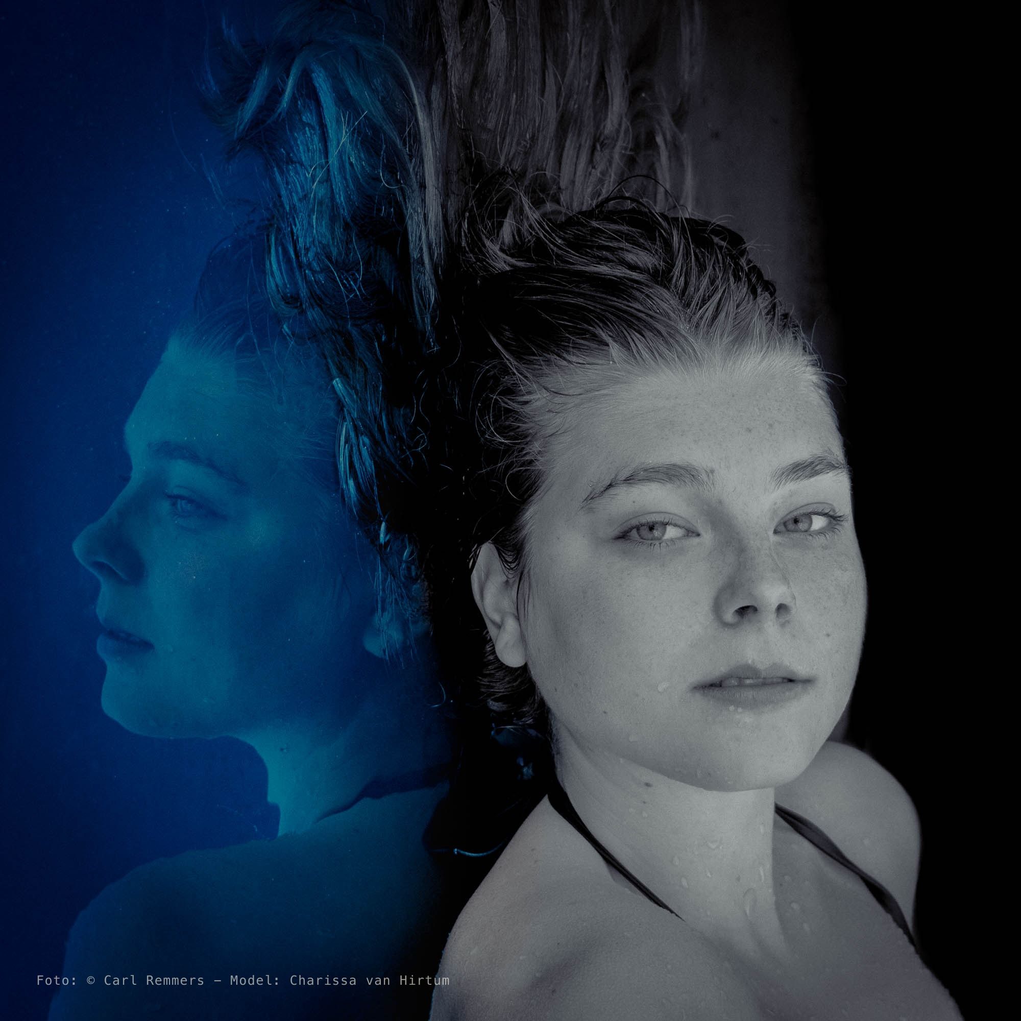 Woman with wet hair, mirrored with a blue half, as if she is lying under water