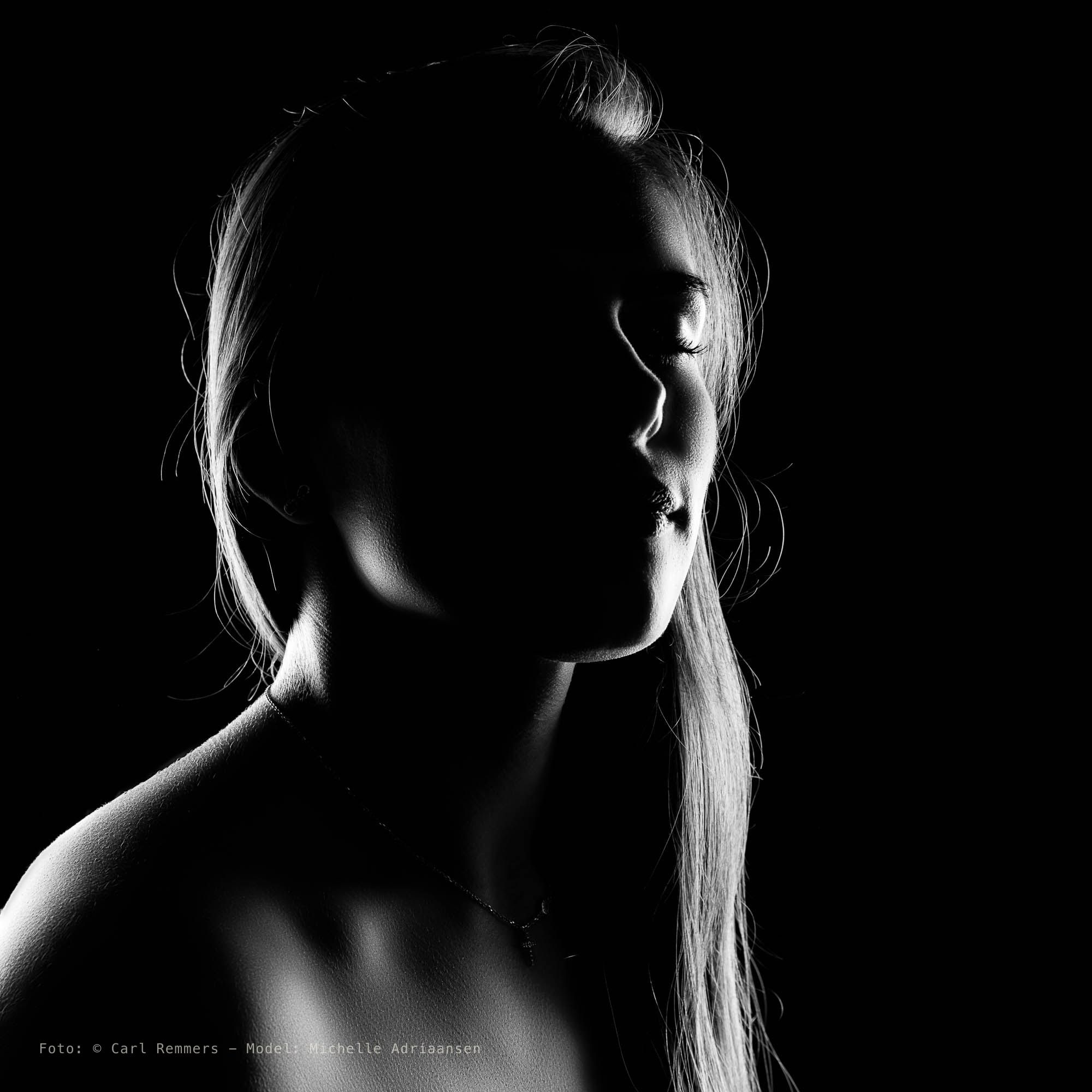 Side profile in backlight, the face mostly in shadow, black and white