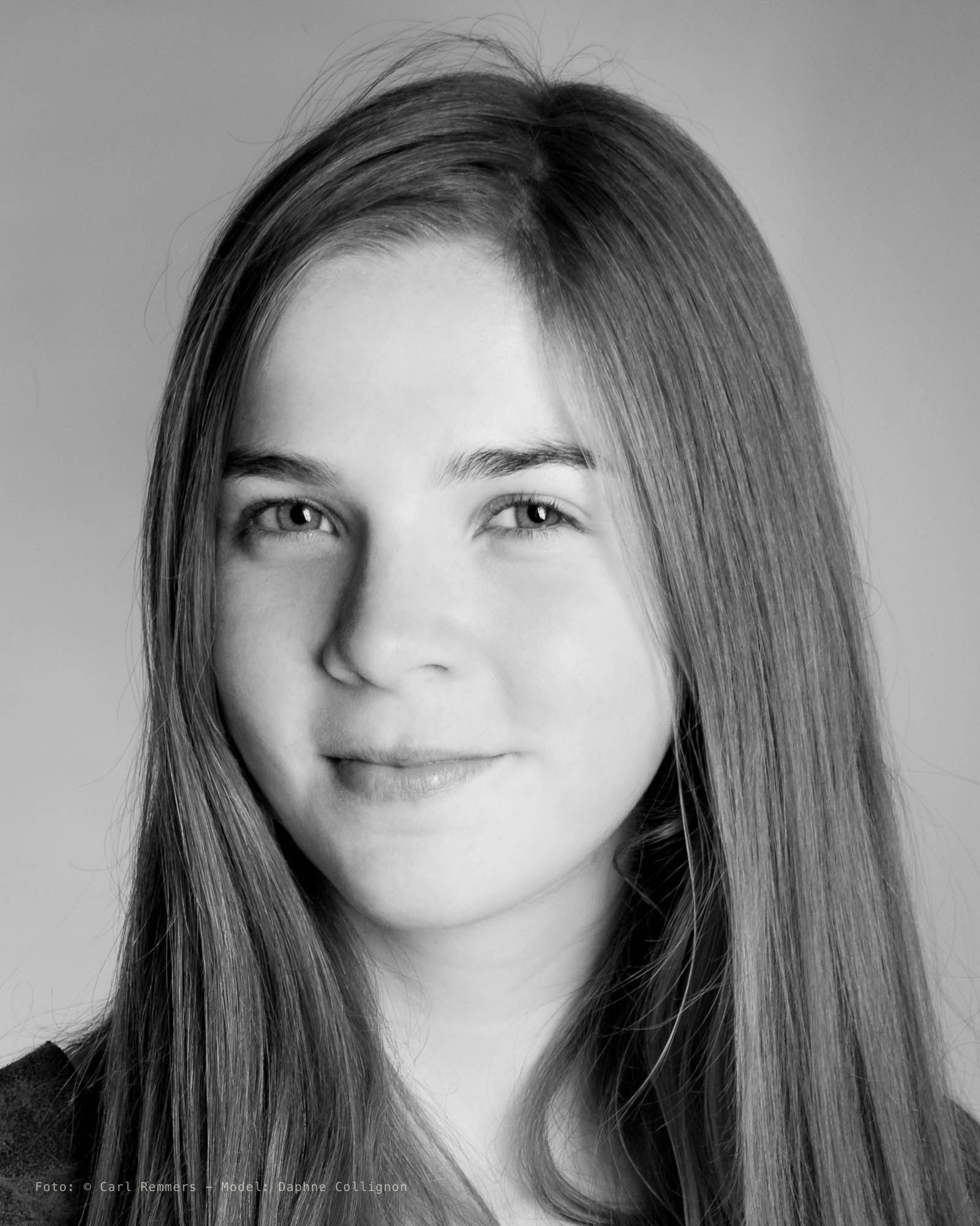Young woman with long straight hair against a light background, black and white